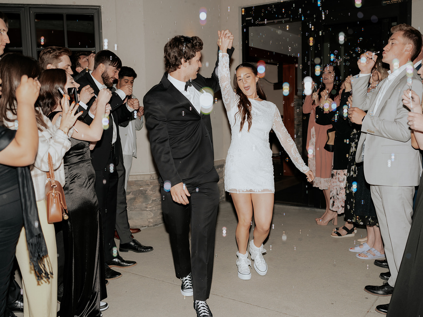 A bride and groom exiting their wedding with bubbles at their ski resort wedding.