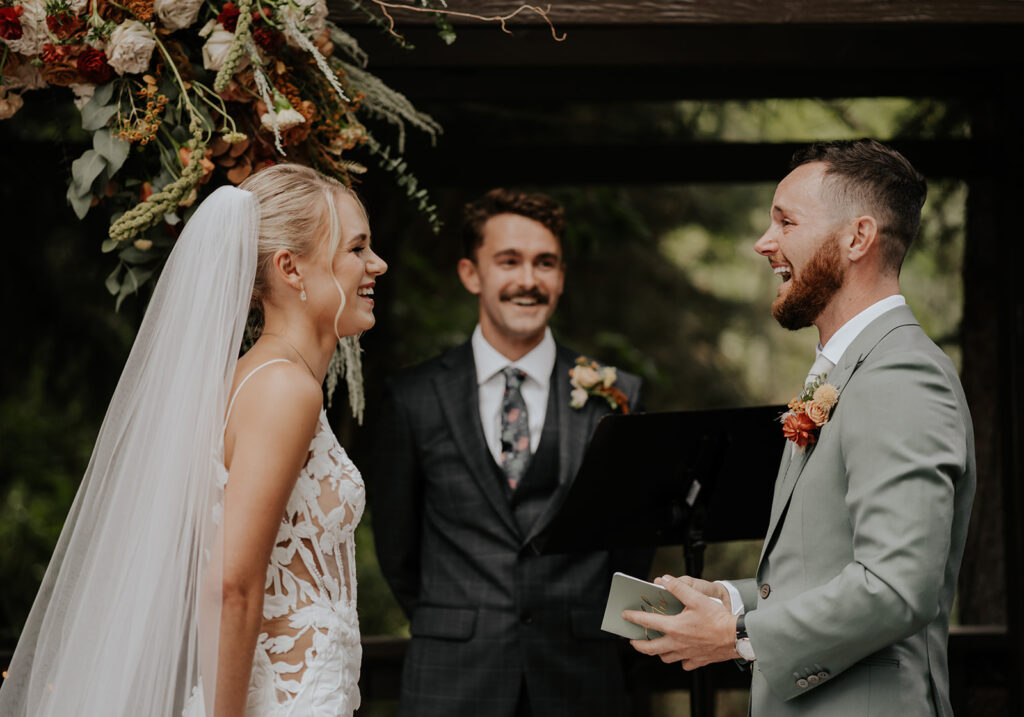 A husband reading his vows to his wife at the altar at their wedding to portray what a photo video team could capture at a wedding.