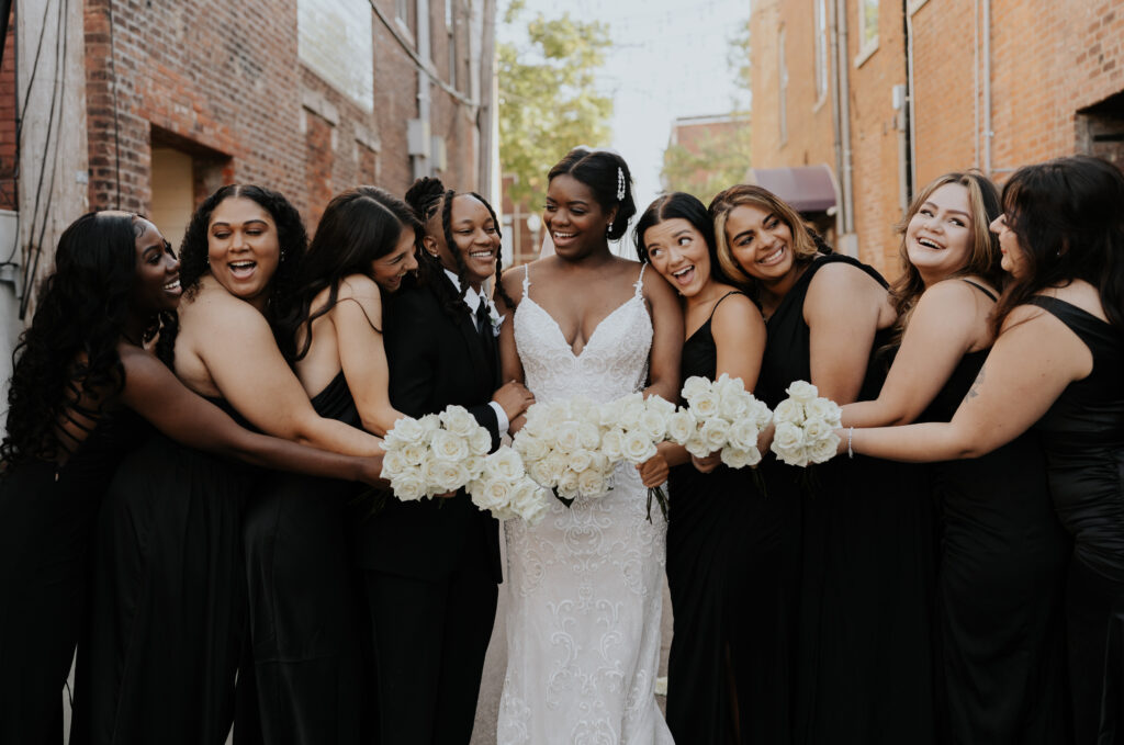 a bride smiling with her bridesmaids on her wedding day captured by a photo video team