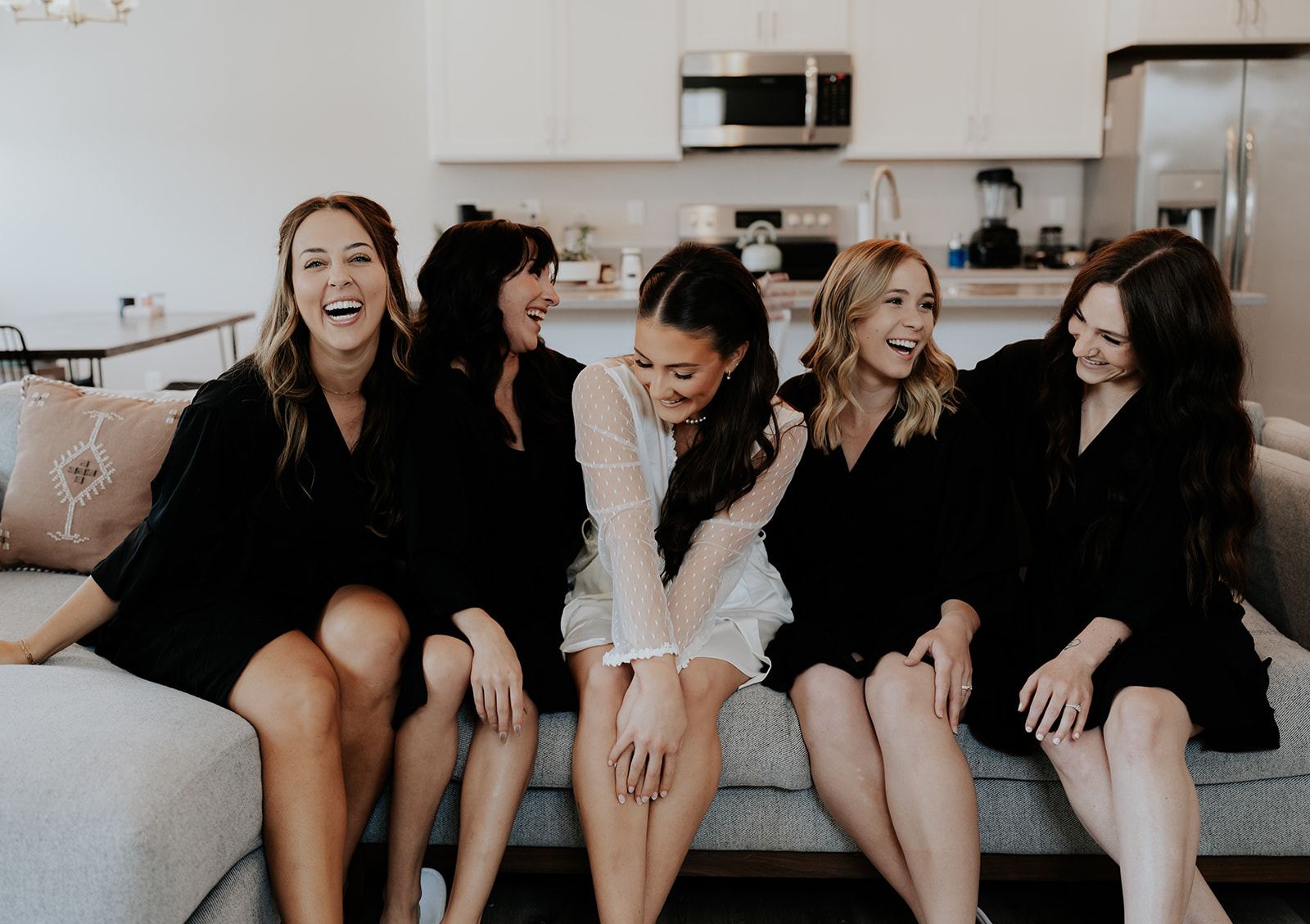 a bride laughing with her bridesmaids