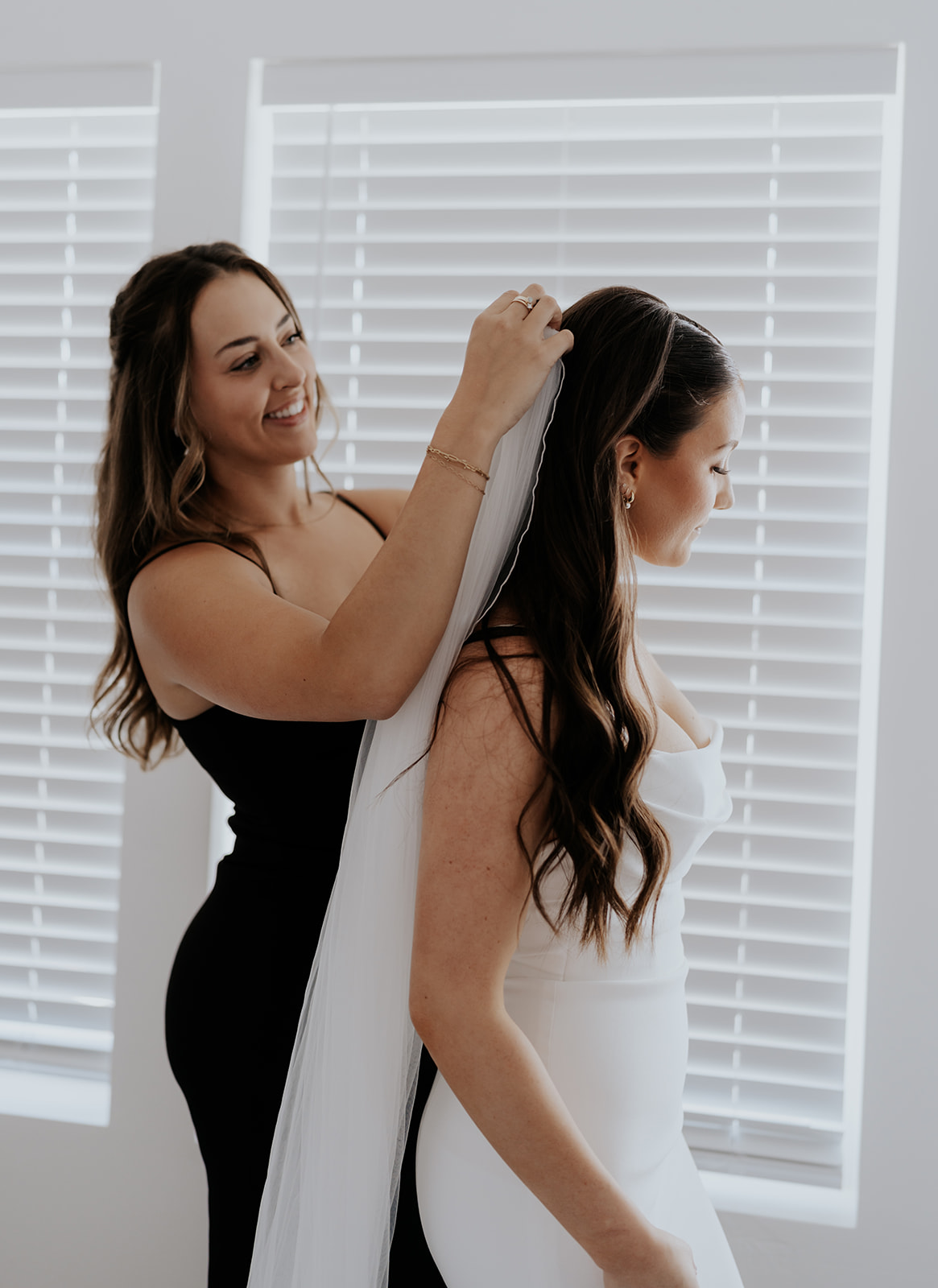 a pride having her veil put in by a family member