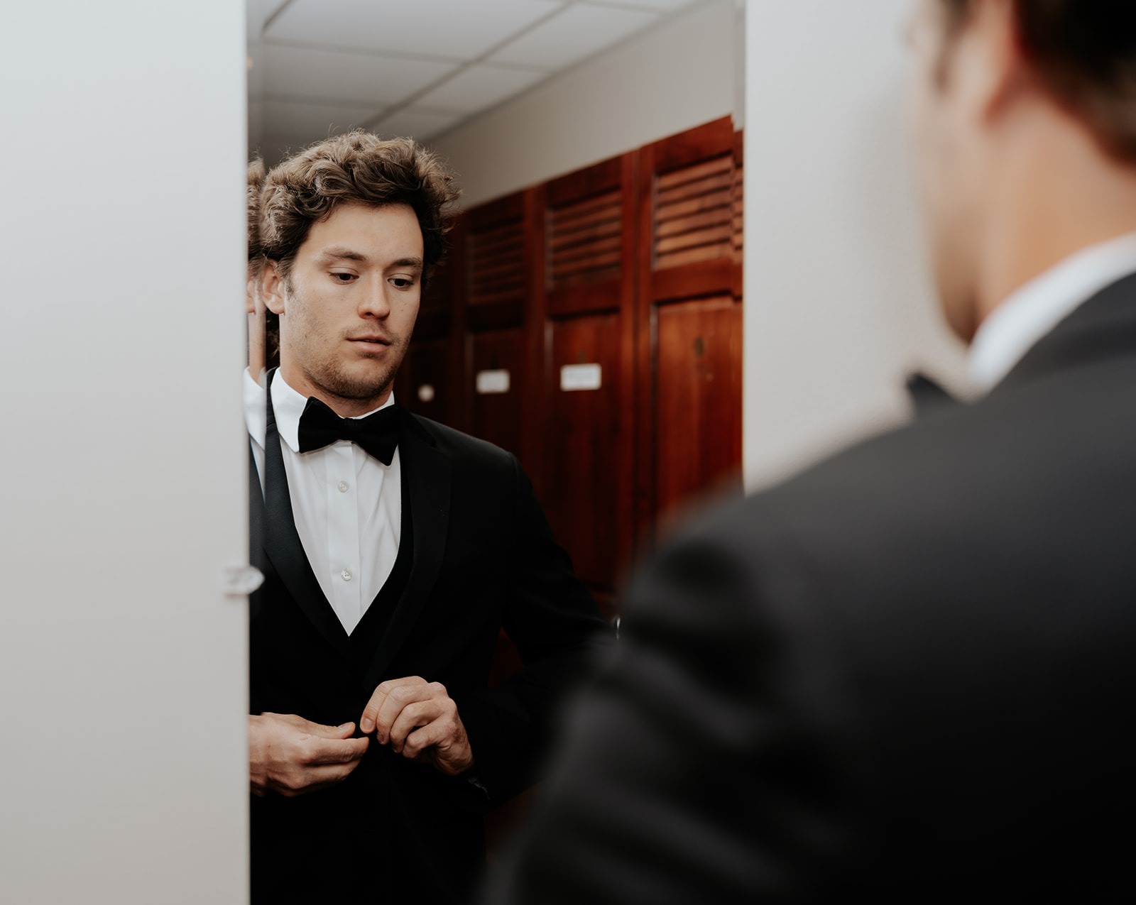 a groom preparing for his ski resort wedding ceremony