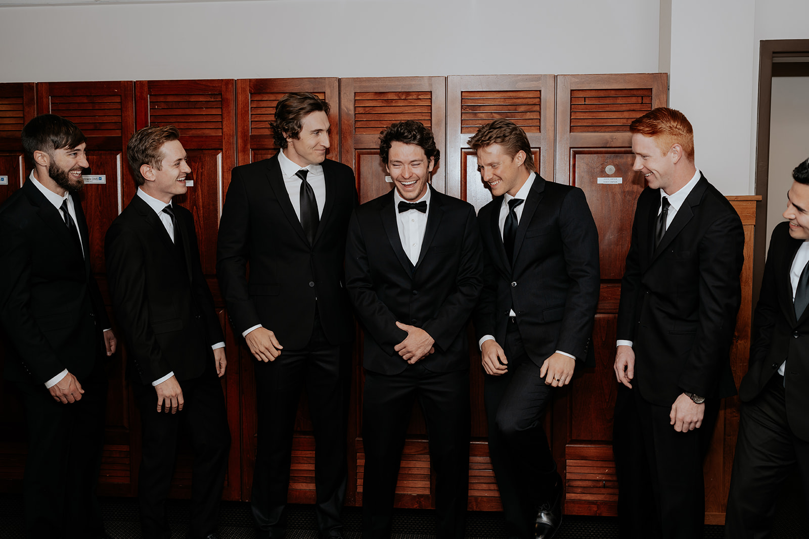 a groom laughing with his groomsmen