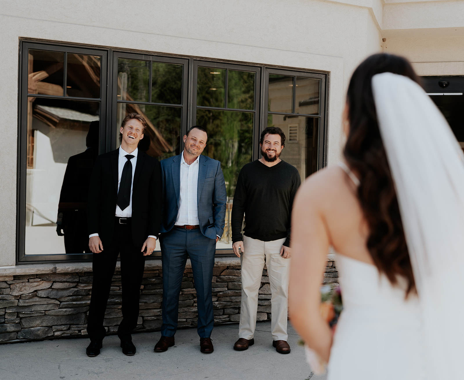 brothers seeing their sister in a wedding dress for the first time.