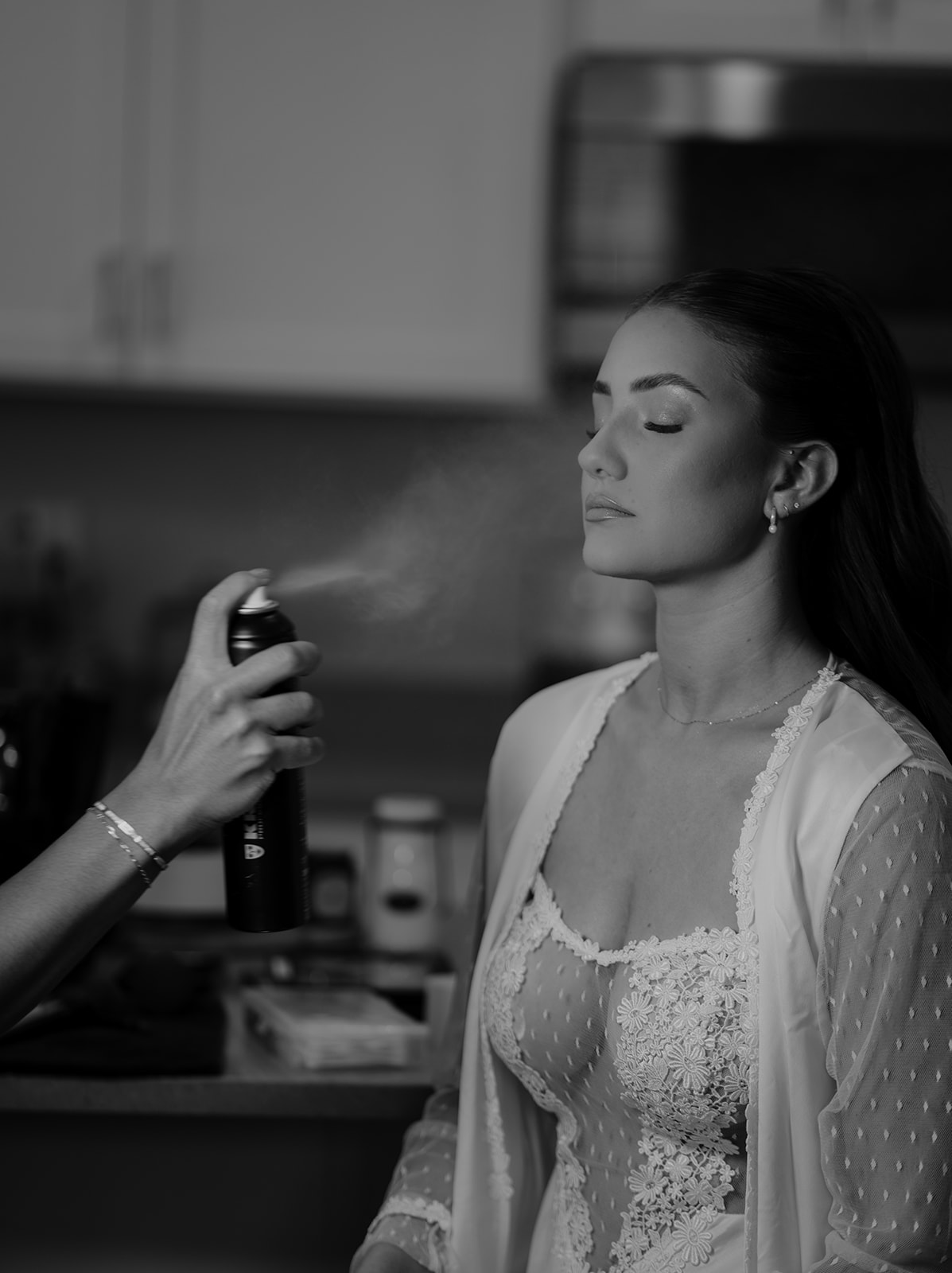 a bride having her makeup done before her wedding