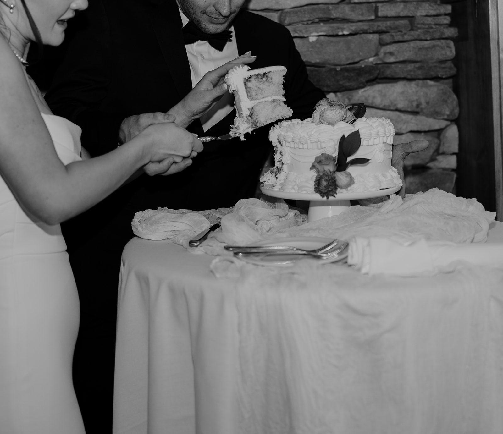 a bride and groom cutting their wedding cake at their wedding reception