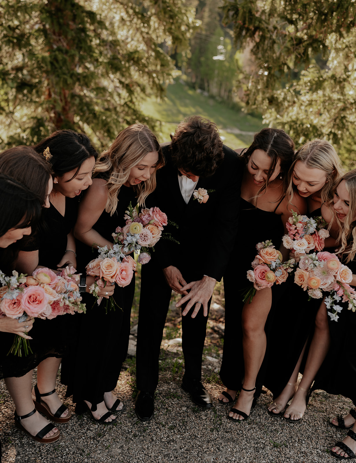 bridesmaids looking at the grooms ring