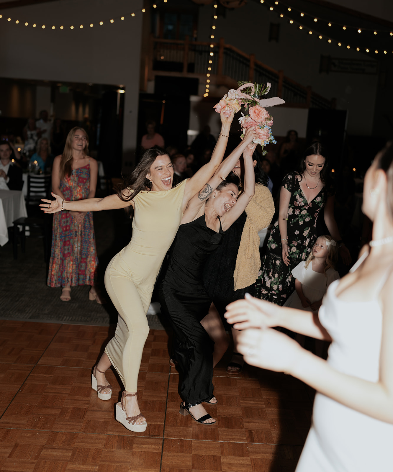 a bridesmaid catching the bouquet at a wedding reception at a ski resort in SLC